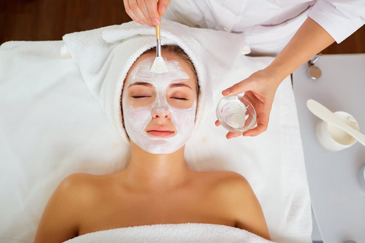 Woman in mask on face in spa beauty salon.